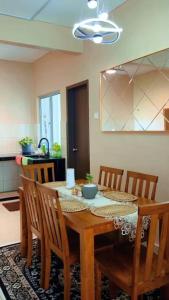 a dining room table and chairs in a kitchen at Aariz Homestay in Malacca