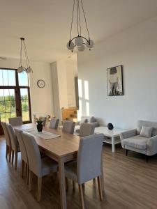 a living room with a wooden table and chairs at Colt de Apuseni in Curăţele