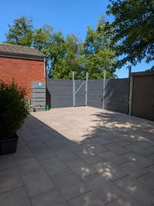 a patio with a fence and a gate in a yard at Ferienwohnung nahe Nordseeküste in Großheide