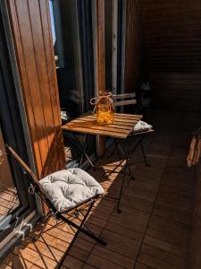 a table on a porch with a lantern on it at Ferienwohnung nahe Nordseeküste in Großheide