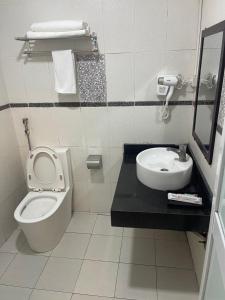 a bathroom with a toilet and a sink at G9 Home hotel in Hanoi