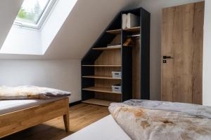 a bedroom with a bed and a book shelf at Chata Vali in Loučovice