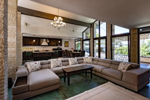 a living room with a couch and a table at Breite Privée Forest and Pool Retreat in Sighişoara