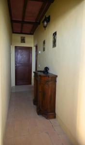 a hallway with a wooden door and a room with a floor at La casa di Mastro Ivetto in Arcevia +5 photos