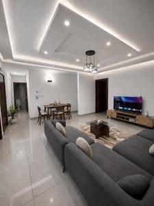 a living room with a couch and a table at Djess in Abidjan +2 photos