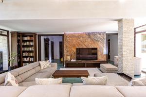 a living room with a couch and a fireplace at Breite Privée Forest and Pool Retreat in Sighişoara