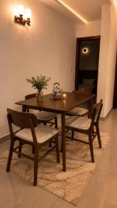 a dining room table and chairs with a table and flowers at Djess in Abidjan