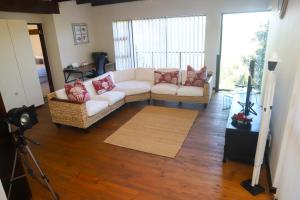 a living room with two couches and a camera at Selah Sands in Port Alfred