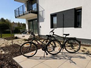 two bikes parked in front of a house at Small Garden Apartman in Sárvár