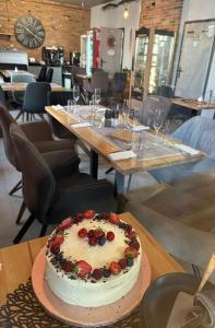 a cake sitting on a table in a restaurant at Apartmány u Bašty in Hlučín