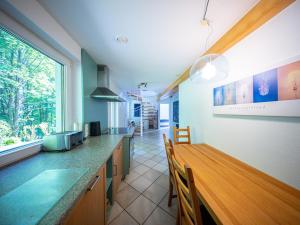 a kitchen with a counter and a table with chairs at Beim alten Forsthaus in Zella-Mehlis +13 photos