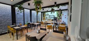 a restaurant with tables and chairs and a large window at Apartamentos Turisticos Paraiso in Funchal