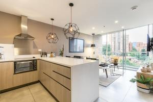 a kitchen with a white counter top and some windows at Soul Lifestyle Hotel in Medellín