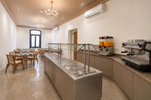 a restaurant with a table and chairs in a room at Malak Palace Cairo Hotel in Cairo