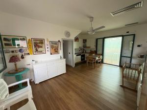 a living room with a dining room and a kitchen at Satiria residence ML in Metaponto