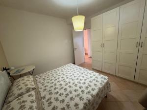 a bedroom with a bed and a table and a lamp at Satiria residence ML in Metaponto