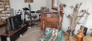 a living room with a tv and a chair at Kyrios Lounge Studio with use of private pool in Carrascal