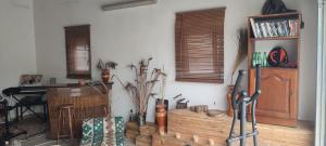 a living room with a wooden shelf and windows at Kyrios Lounge Studio with use of private pool in Carrascal +38 photos