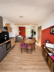 a kitchen and dining room with a table and chairs at Gîte Caussenard rénové in Le Massegros