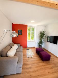 a living room with a couch and a table at Gîte Caussenard rénové in Le Massegros