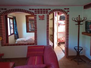 a living room with a couch and a brick wall at WCB Bees in Saint-Vérain