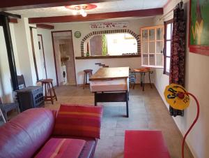 a living room with a couch and a table at WCB Bees in Saint-Vérain