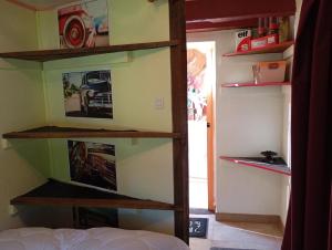 a room with a book shelf with pictures on the wall at WCB Bees in Saint-Vérain