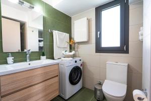 a bathroom with a washing machine and a sink at Lefkada Town Condo in Lefkada +44 photos