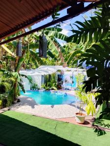 a swimming pool in a yard with trees at Two crazy monkeys in Bakjawan