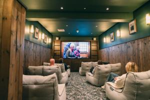 a waiting room with people sitting in chairs watching a tv at CODE - The Court, Edinburgh in Edinburgh