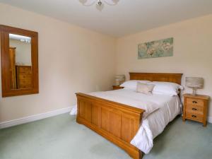 a bedroom with a large bed and a mirror at The Granary in York