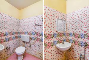 a bathroom with a toilet and a sink at Hotel Ashirbad I comfort Near Railway Station in Bhubaneshwar +17 photos