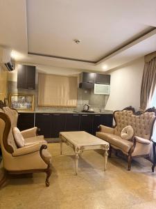 a living room with two couches and a coffee table at Catherine Villa in Lagos