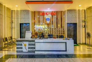 a lobby of a hotel with a reception desk at Hotel Ashirbad I comfort Near Railway Station in Bhubaneshwar