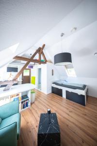 a room with two beds and a couch and a table at Beim alten Forsthaus in Zella-Mehlis