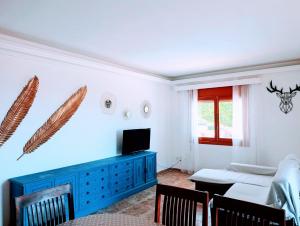 a living room with a blue dresser and a bedroom at Urmi 8 Vista Mar in Peniscola