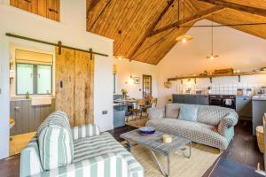 a living room with two couches and a table at 1 Bed in Wickhambrook oc-tosh in Wickhambrook