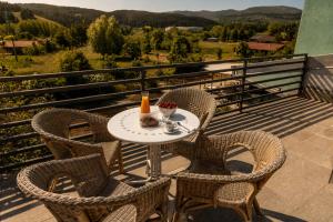 a table with chairs and a drink on a balcony at San Lorenzo Si Alberga in Camigliatello Silano