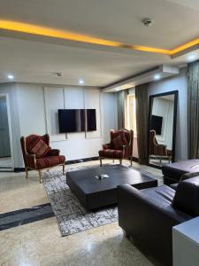 a living room with a couch and a flat screen tv at Catherine Villa in Lagos