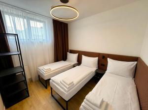 a room with two beds and a window at Factory Suites in Prague
