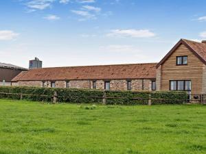 a brick building with a fence in front of a field at 2 Bed in Bristol oc-72836 in Chew Magna