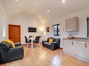 a living room with two chairs and a table at 2 Bed in Bristol oc-72836 in Chew Magna