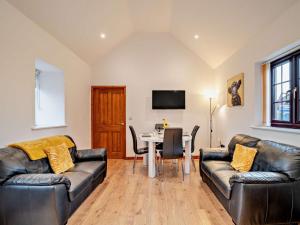 a living room with two leather couches and a table at 2 Bed in Bristol oc-72836 in Chew Magna