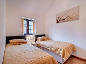 a bedroom with two beds and a painting on the wall at 2 Bed in Bristol oc-72836 in Chew Magna