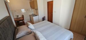 a small room with a bed and a small kitchen at Sunny house KIMI in Omiš