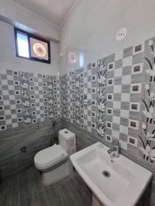 a bathroom with a toilet and a sink at Hotel Rajinder Prasth in Dalhousie +36 photos