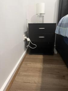 a bedroom with a black dresser with a lamp on it at Private Room in Rockbank in Rockbank