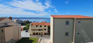 an aerial view of buildings and the water at Sunny house KIMI in Omiš +23 photos