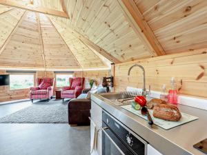 a kitchen with a sink and a stove in a cabin at 1 Bed in Lanark oc-91249 in Libberton +13 photos
