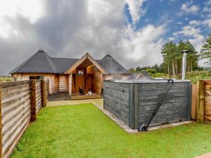 a wooden house with a fence and a yard at 1 Bed in Lanark oc-91249 in Libberton